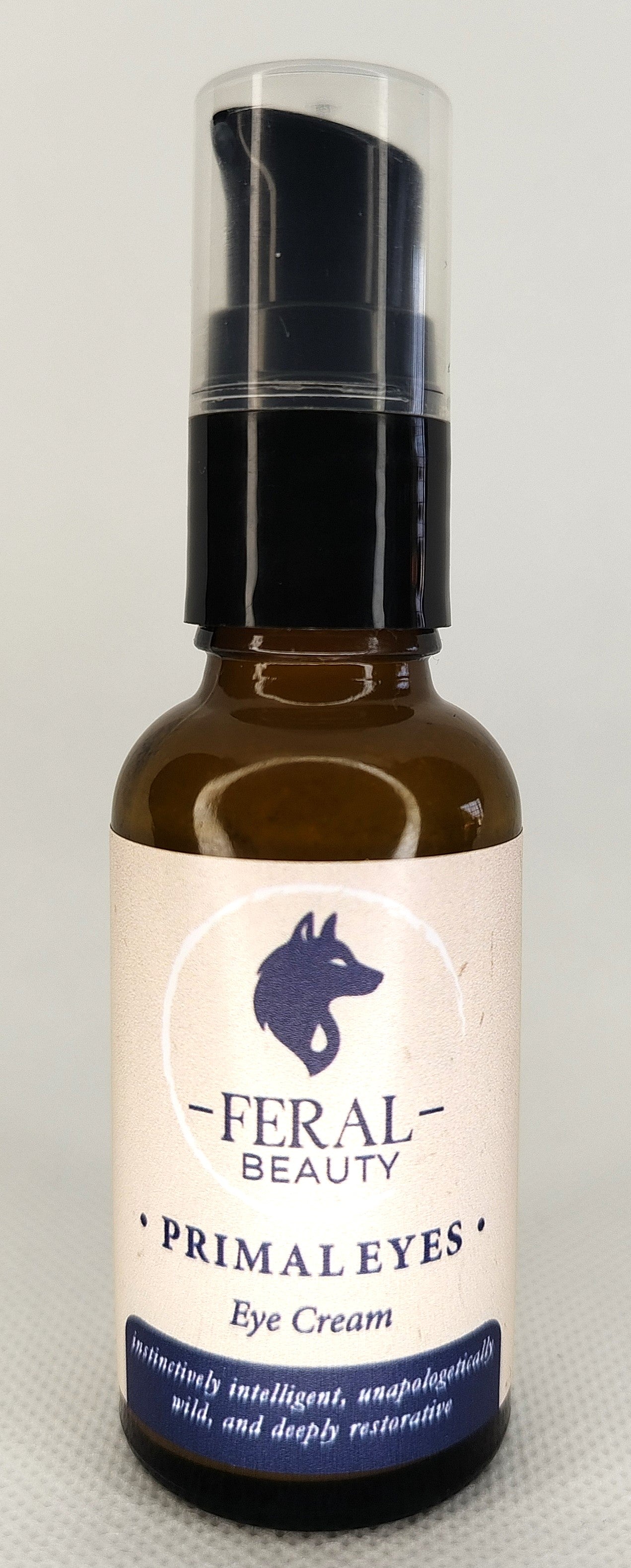 Eye cream bottle labeled 'Feral Beauty Primal Eyes' on a light gray background. Tallow based, animal based anti-aging skincare
