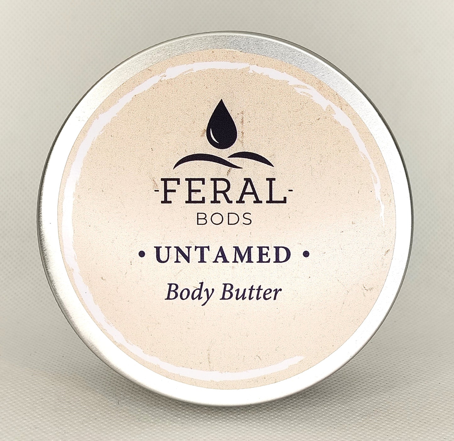 Feral Bods Untamed body butter container on a neutral background
