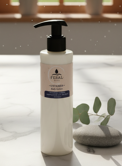 Feral Beauty Emulsified Tallow body lotion bottle on a light surface with a blurred background