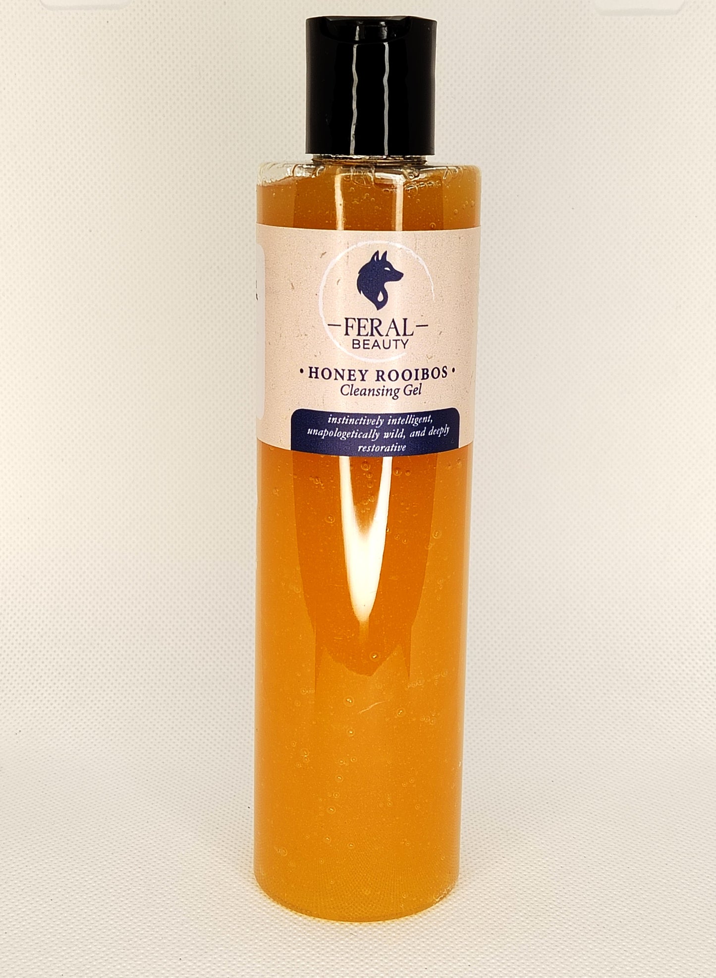 Bottle of Feral Beauty Honey Rooibos Cleansing Gel on a white background tallow based skincare brand