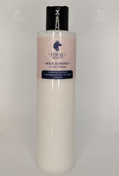 Bottle of Feral Beauty Milk & Honey Cream Cleanser on a light gray background