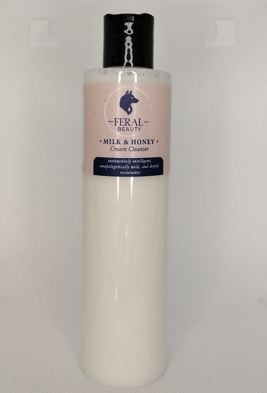 Bottle of Feral Beauty Milk & Honey Cream Cleanser on a light gray background