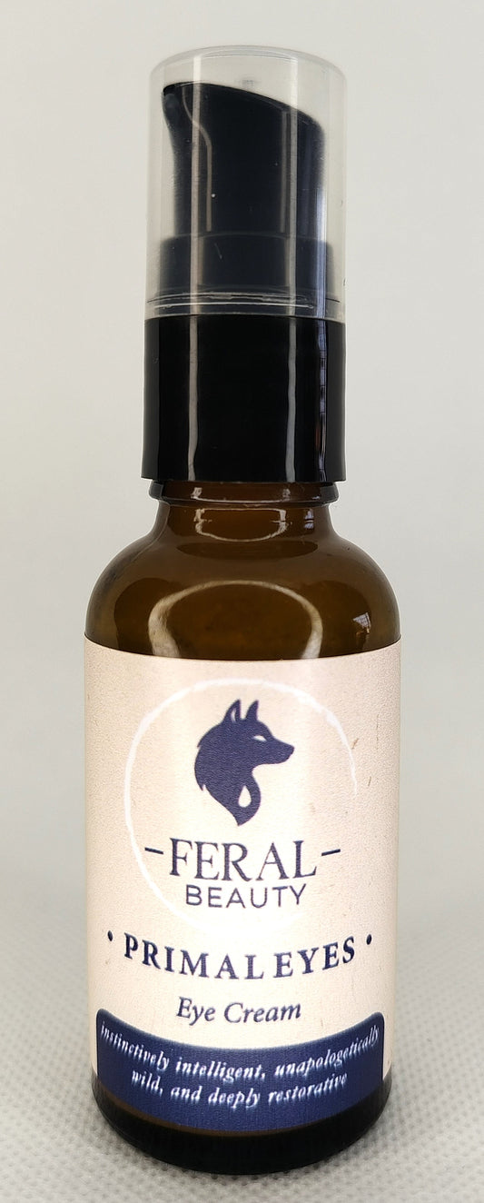 Eye cream bottle labeled 'Feral Beauty Primal Eyes' on a light gray background. Tallow based, animal based anti-aging skincare