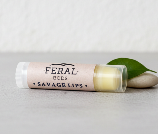 Feral Beauty tallow and bees wax Savage lips lip balm on a grey worktop