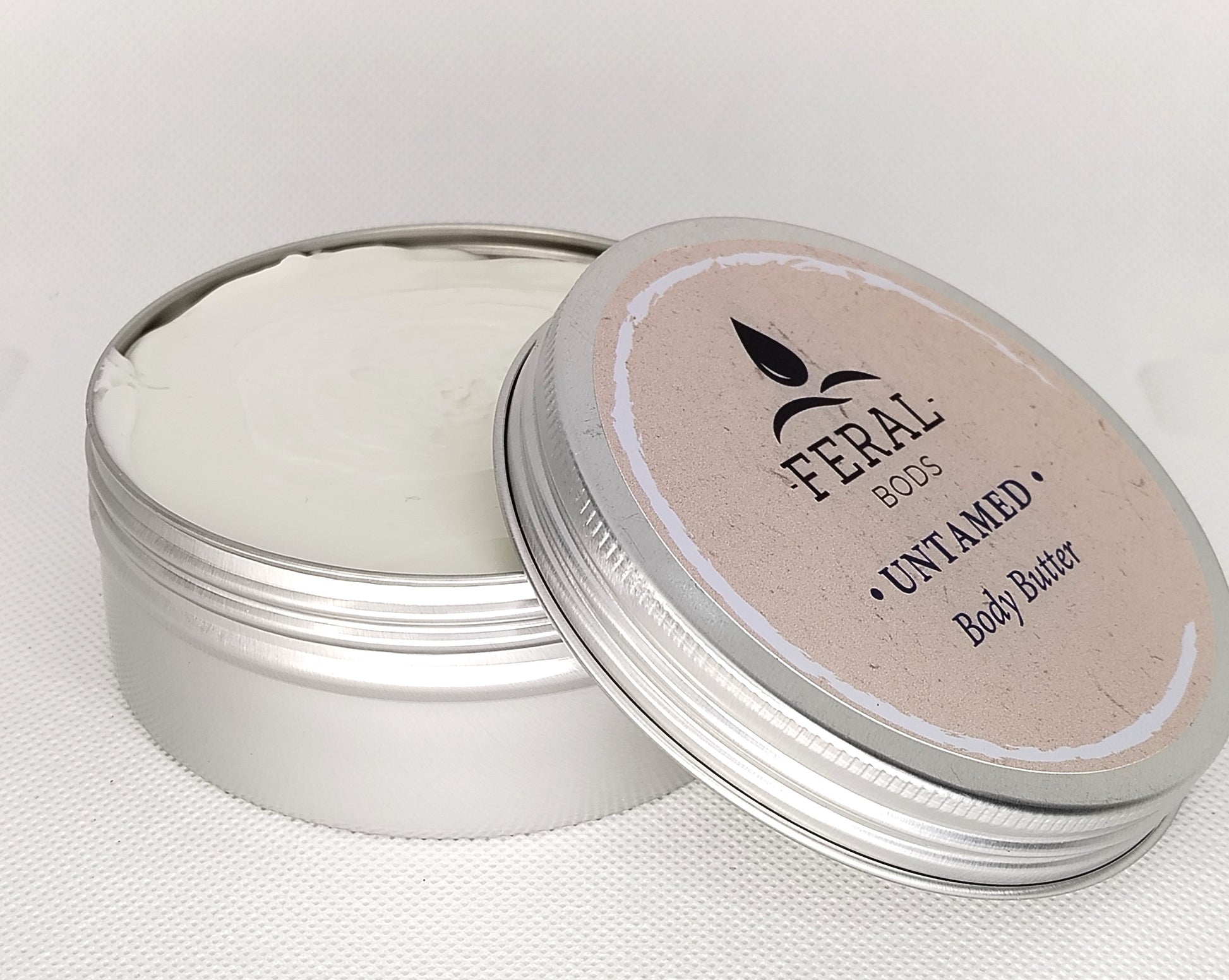 Feral Body Butter container with lid on a white background